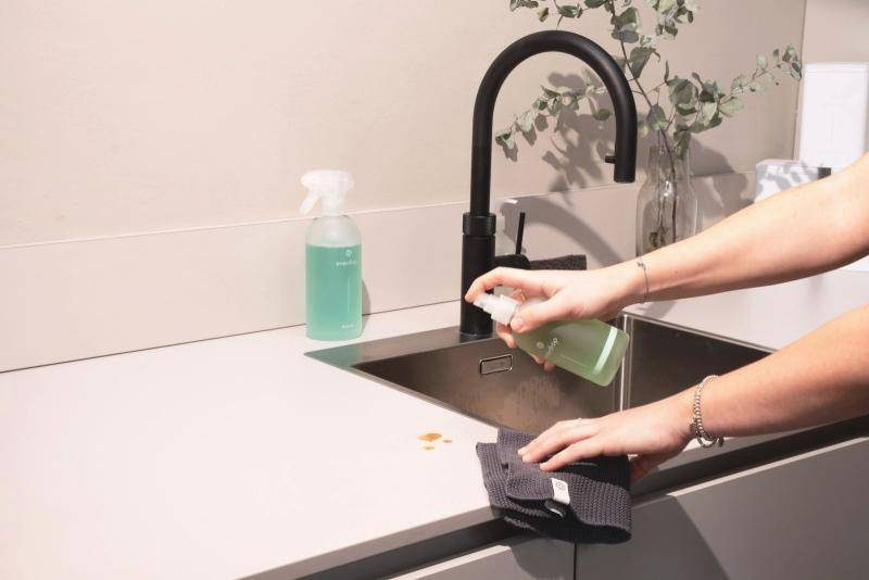 A kitchen worktop being wiped clean